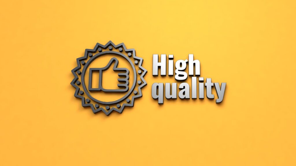 Sign on a yellow wall that says "High Quality" with a thumbs up icon next to it